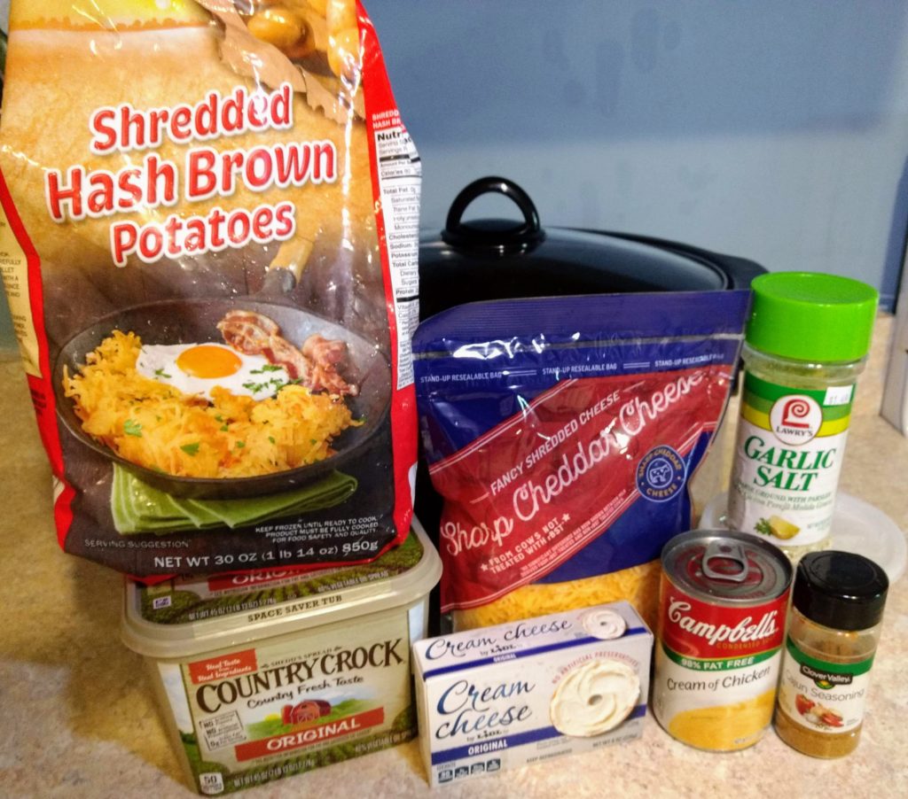 cheesy hash brown casserole ingredients laid out in front of crockpot